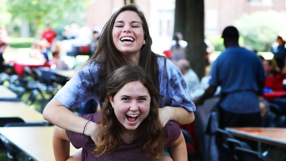 One student gives another a piggy-back ride