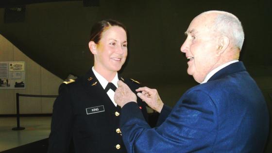 Alumnus Retired Air Force Brigadier General John Rose pins aviator wings on granddaughter Emily King 