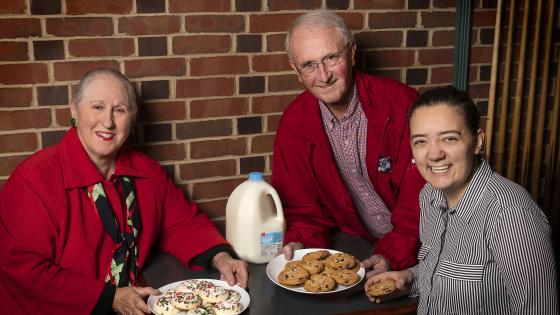 Harriet Kessler, Dennis Appleyard, and Grace Cain ’20 with plates of cookies