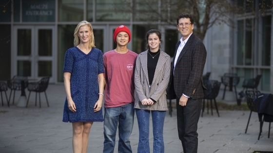 Scholars Michael Yen ’23 and Georgia Morris ’23  standing with scholarship founders Alison Hall Mauzé ’84 and Mike Mauzé ’85 in front of Wall building