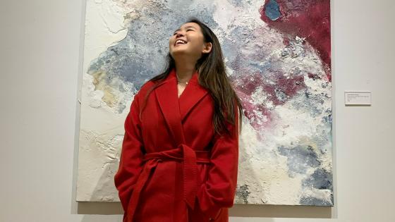 Student Coco Peng Posed in Front of Painting Looking Up 
