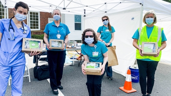 Healthcare Personnel holding lunch boxes