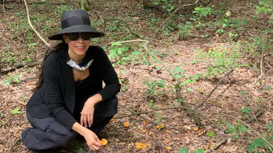 Prof. Courtney Lewis kneeling with chanterelles