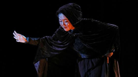 Ariel Chung in Macbeth wearing cape and mask