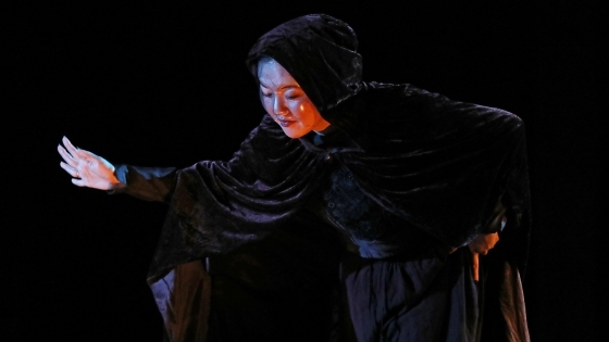 Ariel Chung in Macbeth wearing cape and mask