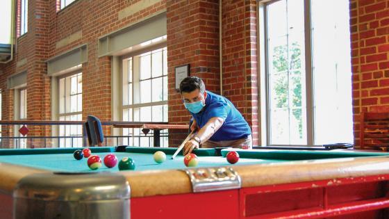 Student Plays Pool with Mask On