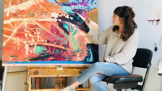 Adelle Patten with a painting