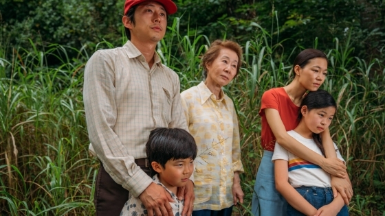 Family embraces in front of greenery