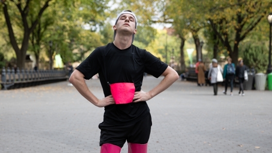 Davidson College alum Dan Van Note '14 in thigh-high boot heels with sneakers on ground for 2019 Endurance Queen performance