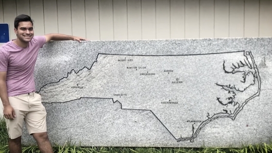 Tim Schietroma '25 in front of a map of North Carolina