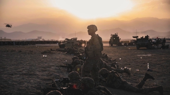 Matthew Hardman in Army Gear Among Sand