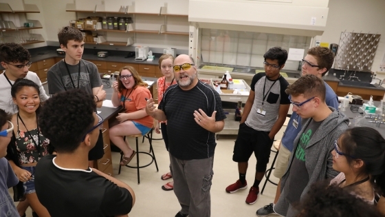 Durwin Striplin in Classroom with Students Gathered Around Him