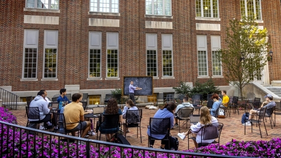 class being taught outdoors by Wall Academic Building