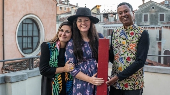 Co-curators Jennifer Garcia Peacock (center) and Subhankar Banerjee with Lucia Pedrana, head of university relations, European Cultural Centre, Venice, celebrate their award for A Library, a Classroom, and the World, at a Nov. 27 ceremony.