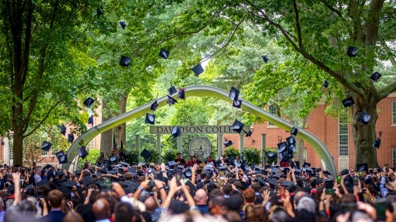 Graduation caps in air during ceremony