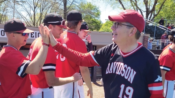 President Douglas Hicks hive fiving baseball player Tyler Douglas