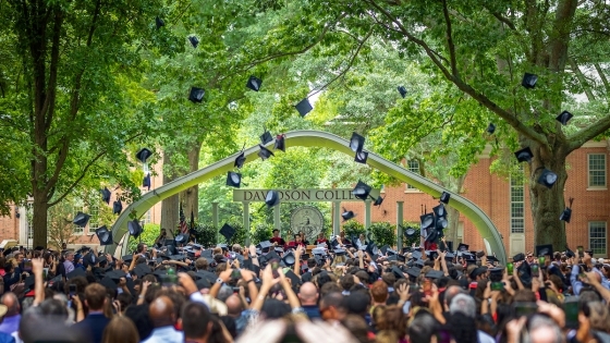students throwing their caps in the air at commencement
