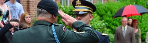 Military official salutes ROTC student outside