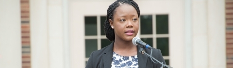 Jocelyn Kennedy '17 stands at podium in front of Chambers for the Law School Induction Ceremony