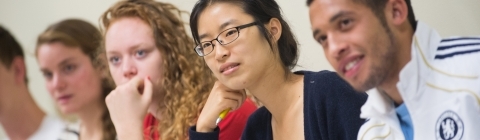 Photo of five students listening to a class lecture