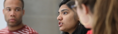 Student talks in class while peers look in her direction