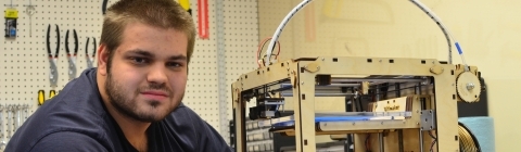 Student at Studio M sets up a 3D printer