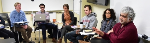 Arab studies class arranges desk in a circle while listening to a discussion led by Khaled Khalifa, a Syrian screenwriter and novelist