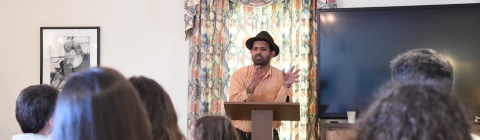 Students heads face Prof. Zamir as he stands at a podium and speaking