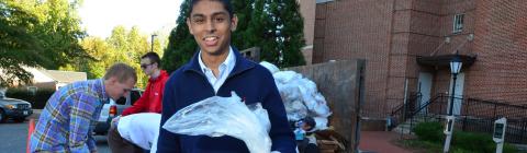 Student holds bag of recycling