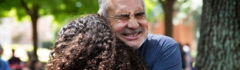 Family member hugs a student while saying goodbye at the Orientation Farewell Picnic on Chambers Lawn