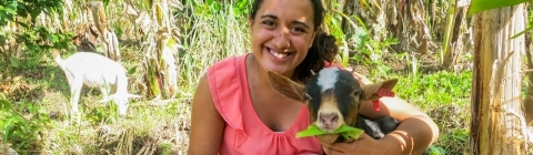 Student doing Nourish Internship interacts with a goat