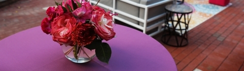 Event with colorful table cloths and pink flowers