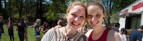 Patterson court during Frolics, students pose together after grabbing a funnel cake