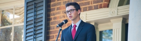 Student stands at Eu Hall for political debate