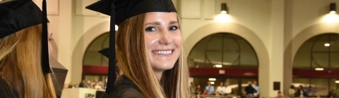 Commencement profile of student inside Baker Sports Complex