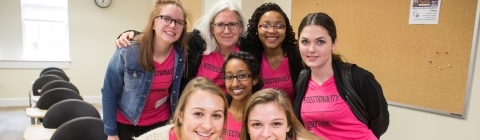 Women's Leadership Conference speakers gather in a classroom