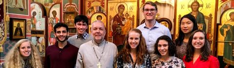 Interfaith club visits an orthodox christian church and poses with priest
