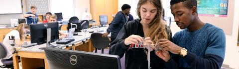 Students conduct experiments in physics lab