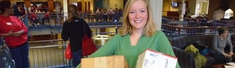 Student holds three packages