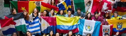 Students hold flags from many different countries