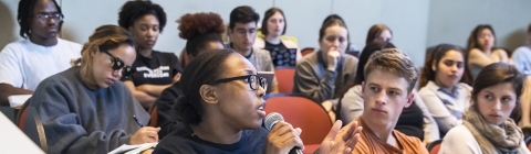 Classroom scene w student speaking at microphone