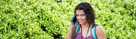 July Experience Student Walks on Campus on the Phone