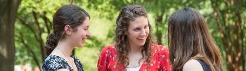 Students talk in small group at a Dean Rusk student gathering outside