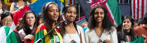 Students hold Ethiopian flag while students around them hold other international flags