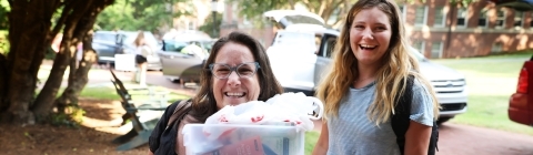 Student and her family member unload the car