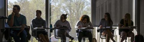 Wall Center Students sitting at desks in class with window behind