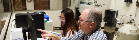 Prof. Blauch and Student working with large chemistry equipment