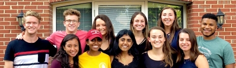 Health Advisers pose in front of brick wall