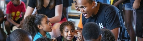 Students lead singing with kids from Freedom Schools