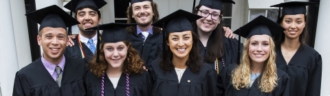 Graduating Belk Scholars in caps and gown pose in group
